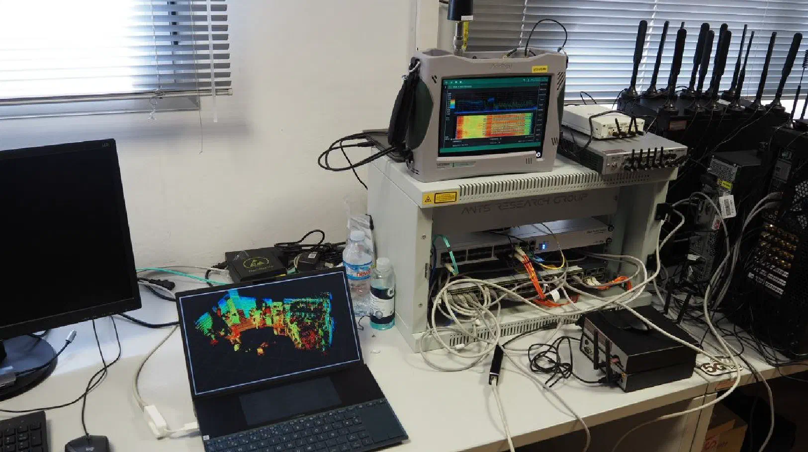 Test bench at Gaia Lab with a spectrum analyser, SDR units and the ANTS research group rack