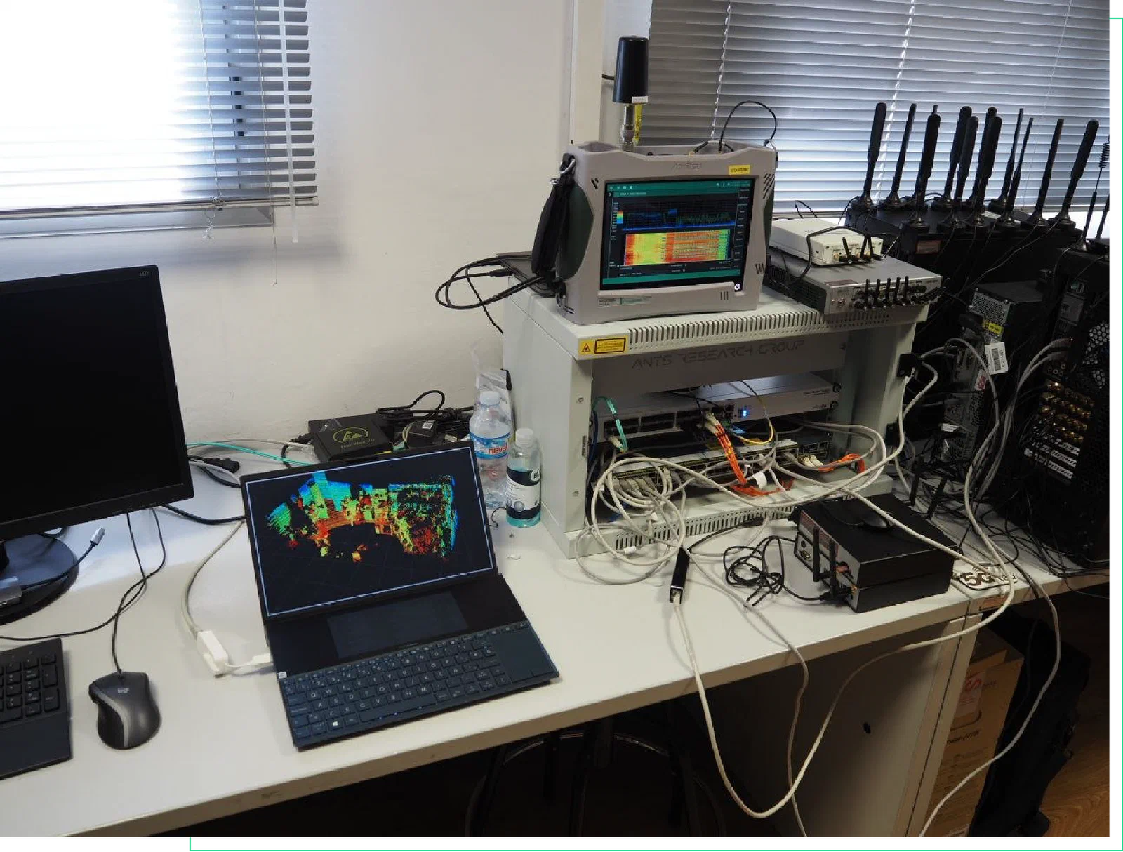 Measurement bench at Gaia Lab: Anritsu FieldMaster Pro spectrum analyser on top of the ANTS research group rack, SDR units and a laptop showing a LiDAR point cloud