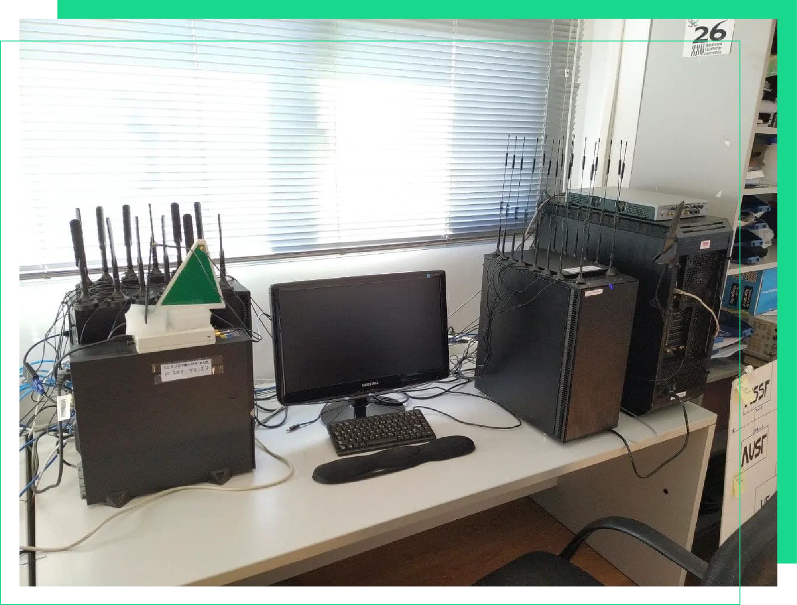SDR workbench at Gaia Lab: computers fitted with antenna arrays next to Ettus software-defined radio units